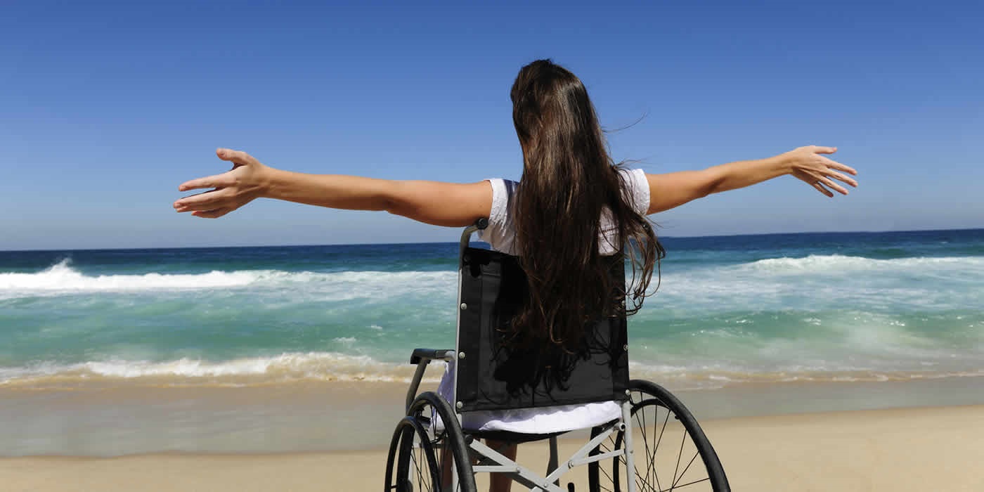 Lady In Wheelchair On Beach